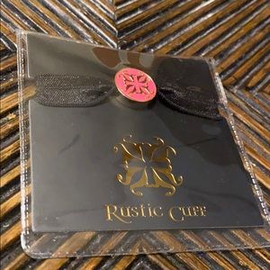 RC black elastic bracelet with pink/gold emblem